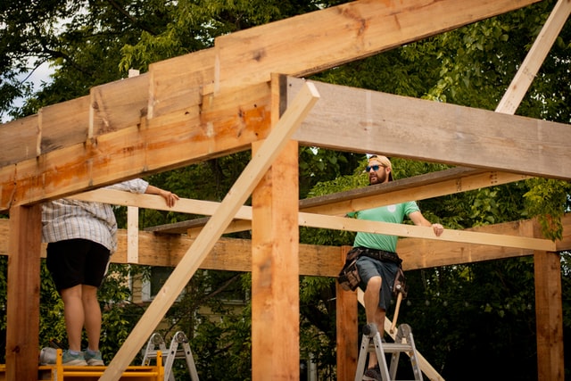 Two men framing a garage