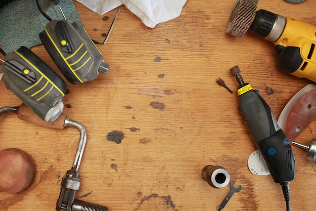 close up of a work bench with a variety of tools and safty gear